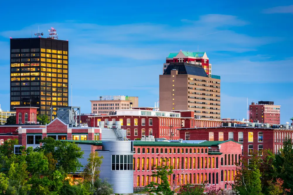 Manchester New Hampshire skyline at dusk — rental property investment financed with a DSCR loan — The Doce Mortgage Group