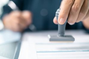 BankingOfficerStampedTheDocumentToApproveTheLoanFinalizing